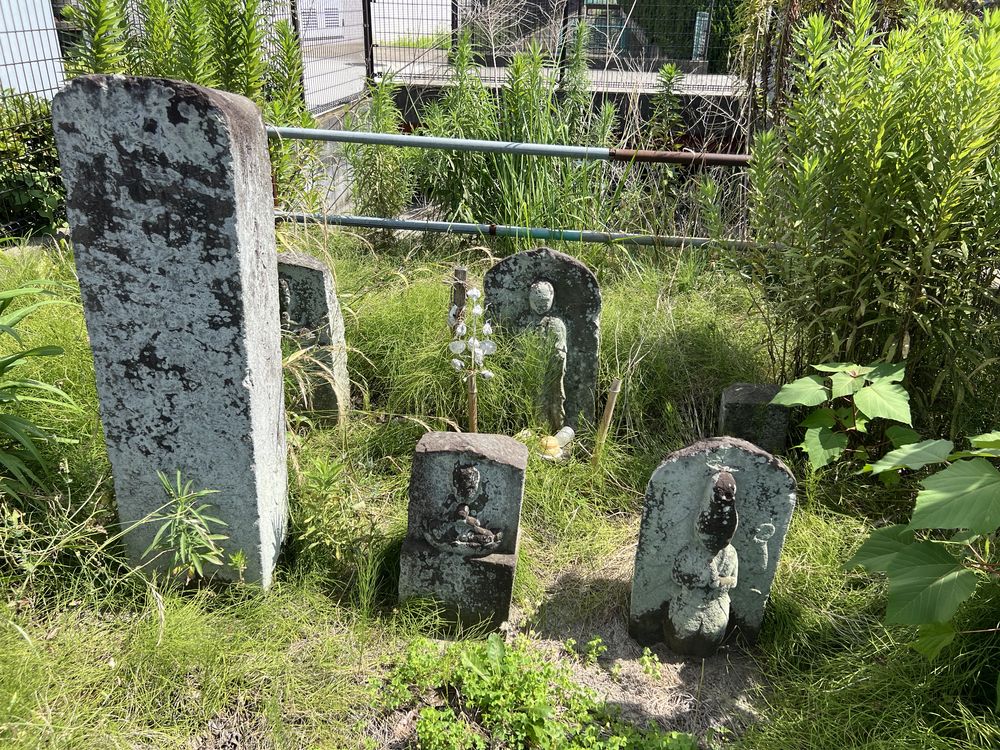越谷市平方の天草病院角地（会の川暗渠上）にある石塔群